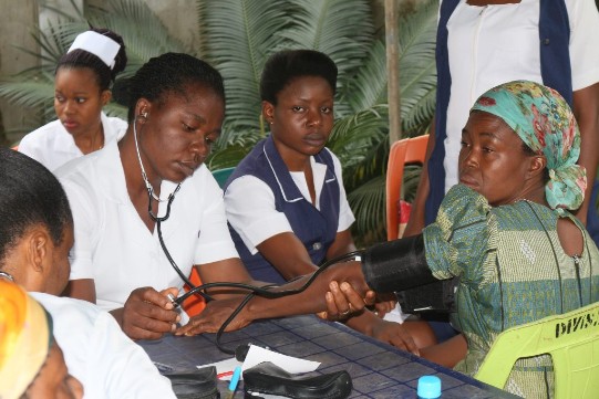 Nurse checking villagers - Growing Trees International Ministries